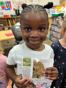 child with panera cookie