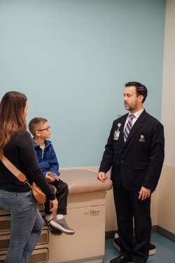 Surgeon talking to mom and little boy during appointment