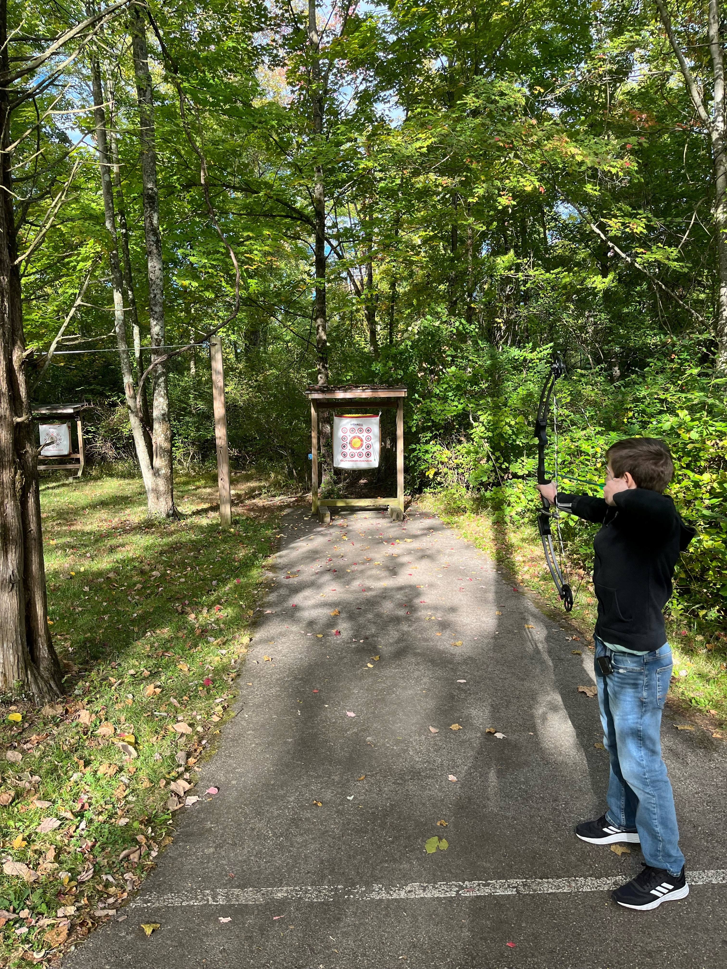 Corin doing archery holding a bow and arrow