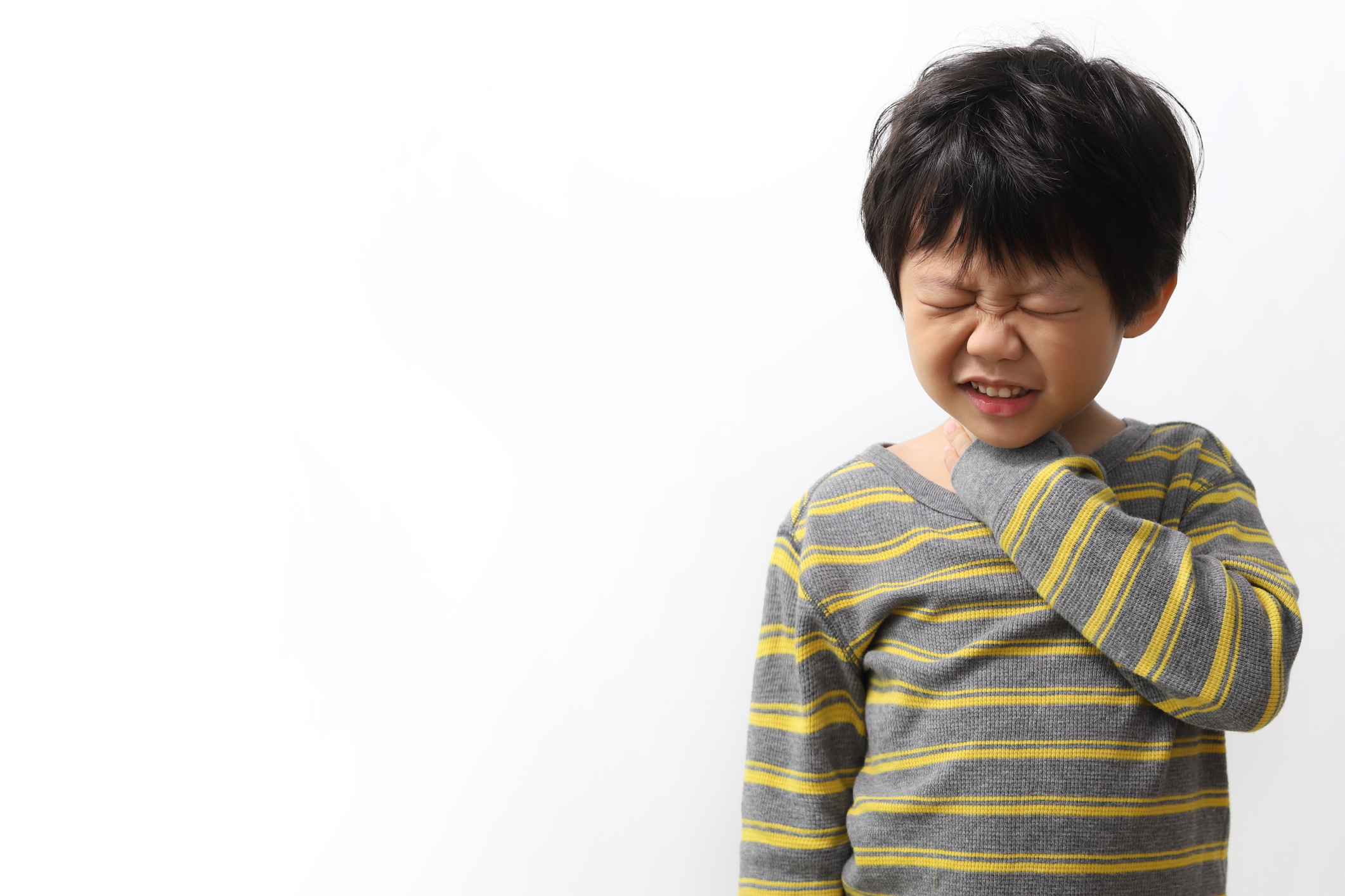 young boy holding neck sore throat