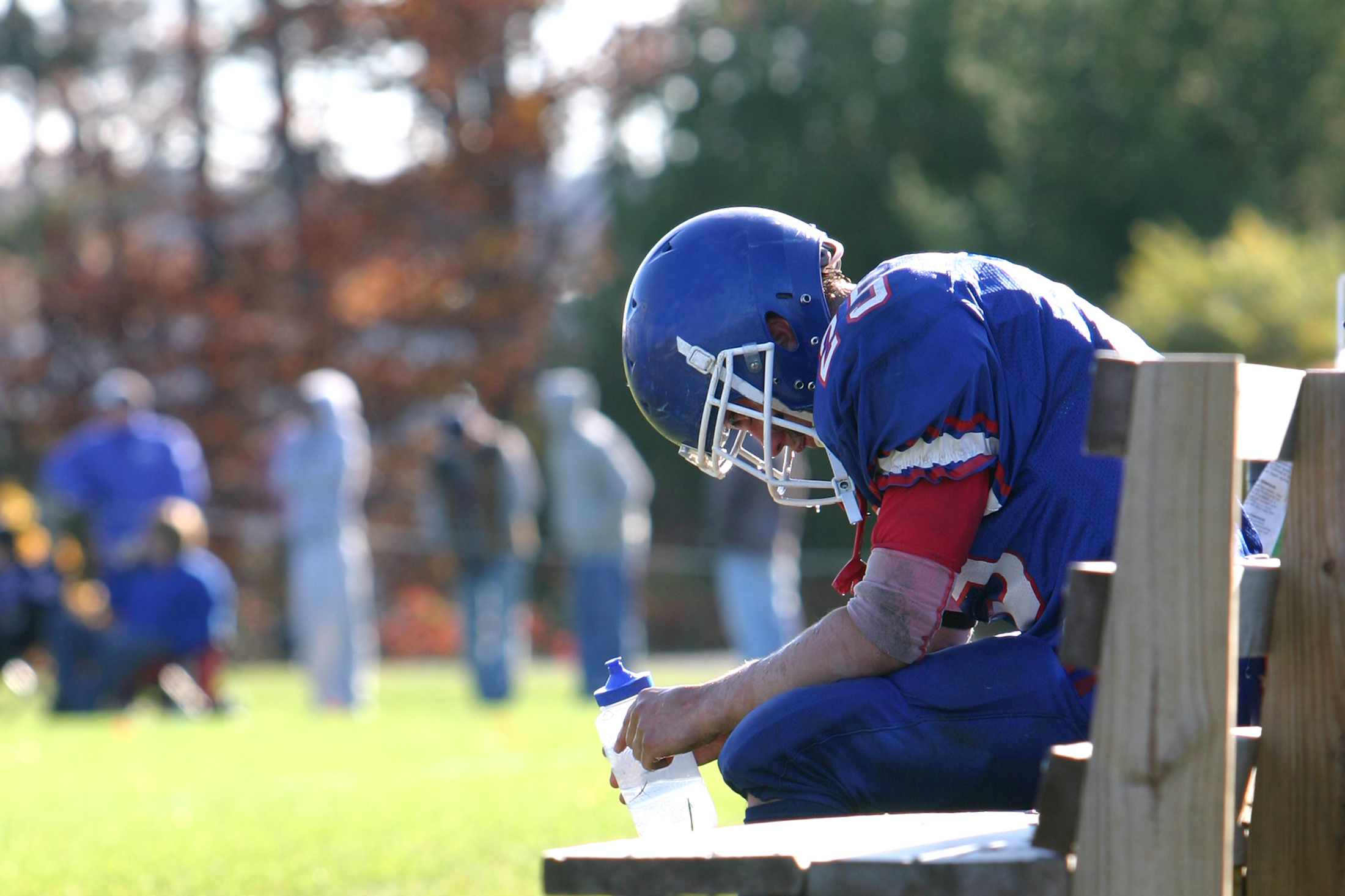 exhausted football player on bench