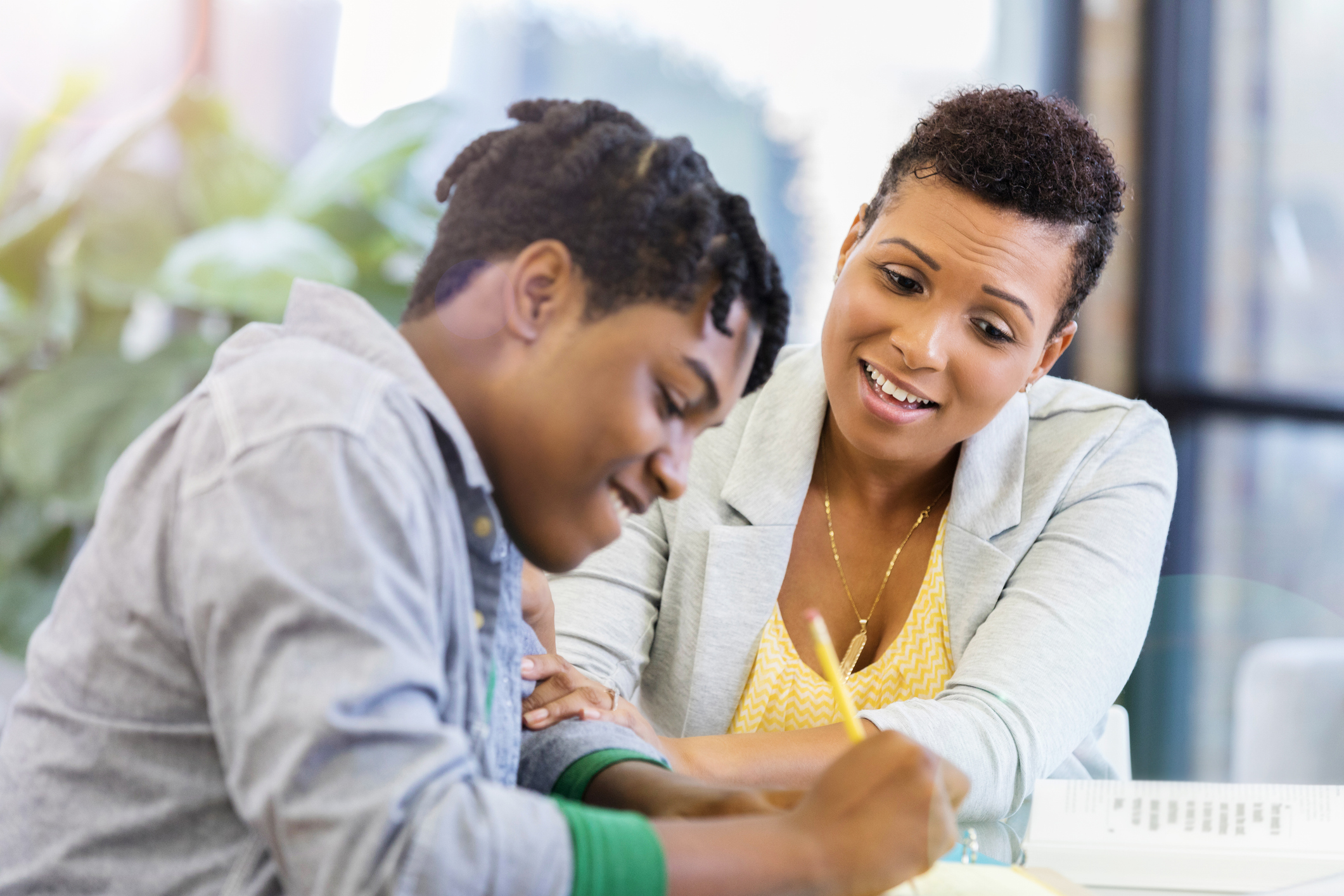 mom and son doing homework at kitchen table