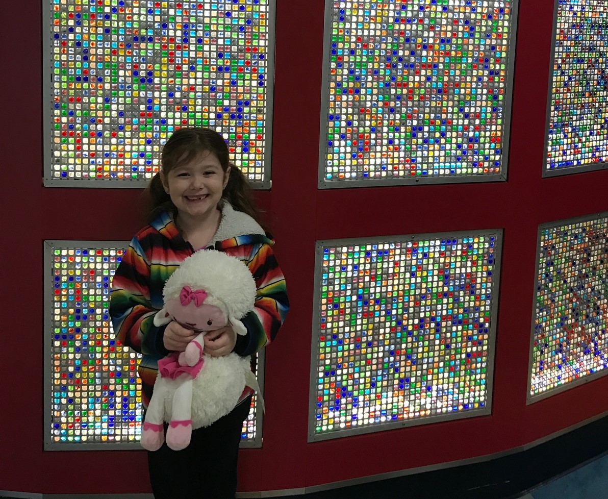 Young Samantha holding a stuffed animal