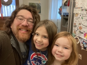 Erich Koenig posting for a selfie with his two daughters