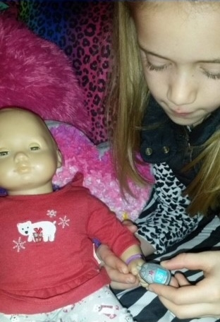 Adi Tucker - checking her doll's BG