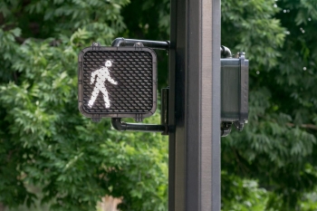 light at a crosswalk telling person to walk