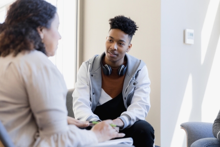 African American teen talking with therapist