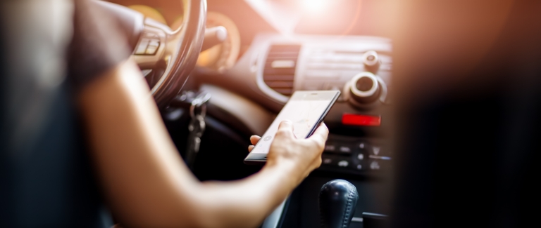 person using phone while driving