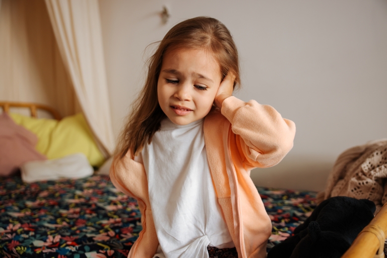 little girl with earache or ear infection