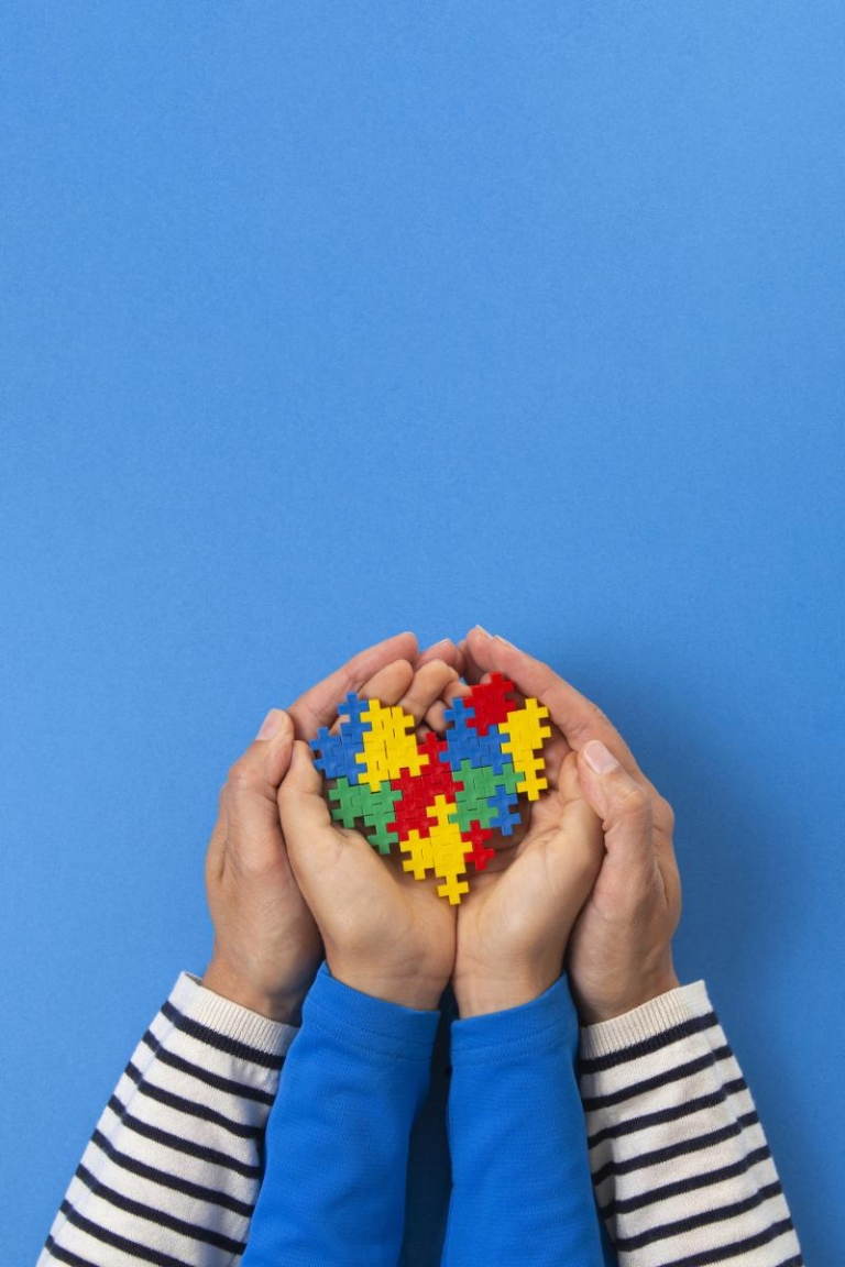 autism puzzle symbol in hands