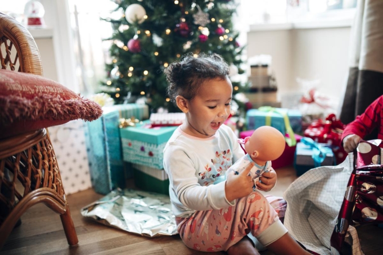 girl with baby doll and Christmas tree