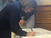 Debbie signing agreement